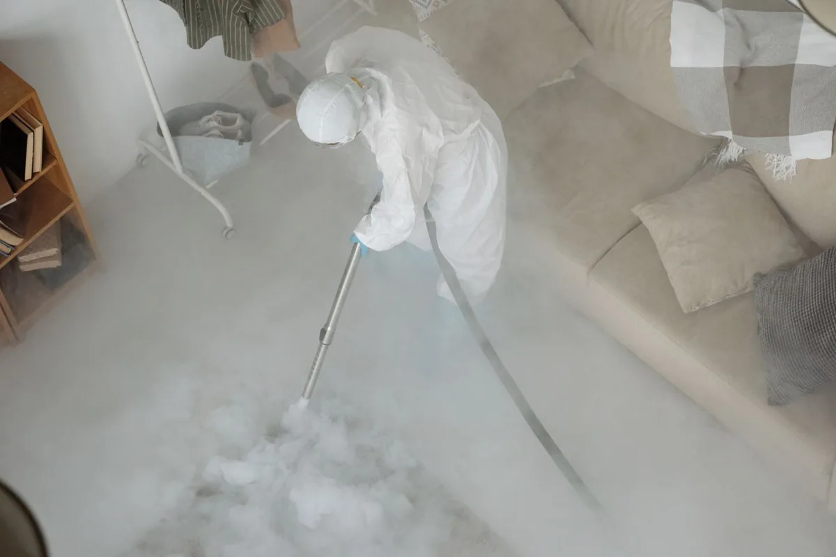 Biohazard cleanup technician in protective equipment, Dyker Heights, New York, NY